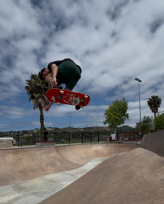 Skater in the air over a concrete bowl
